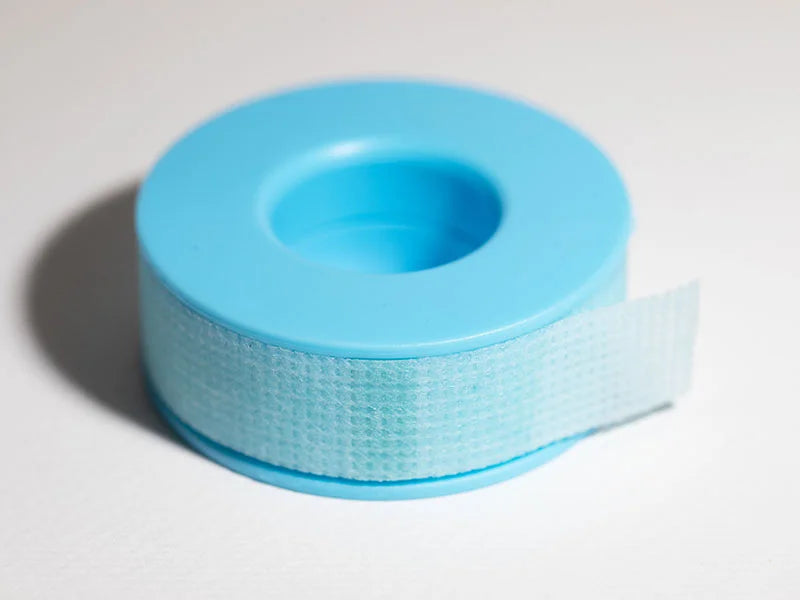 Light blue silicone gel tape wound on a matching plastic spool for secure adhesive applications