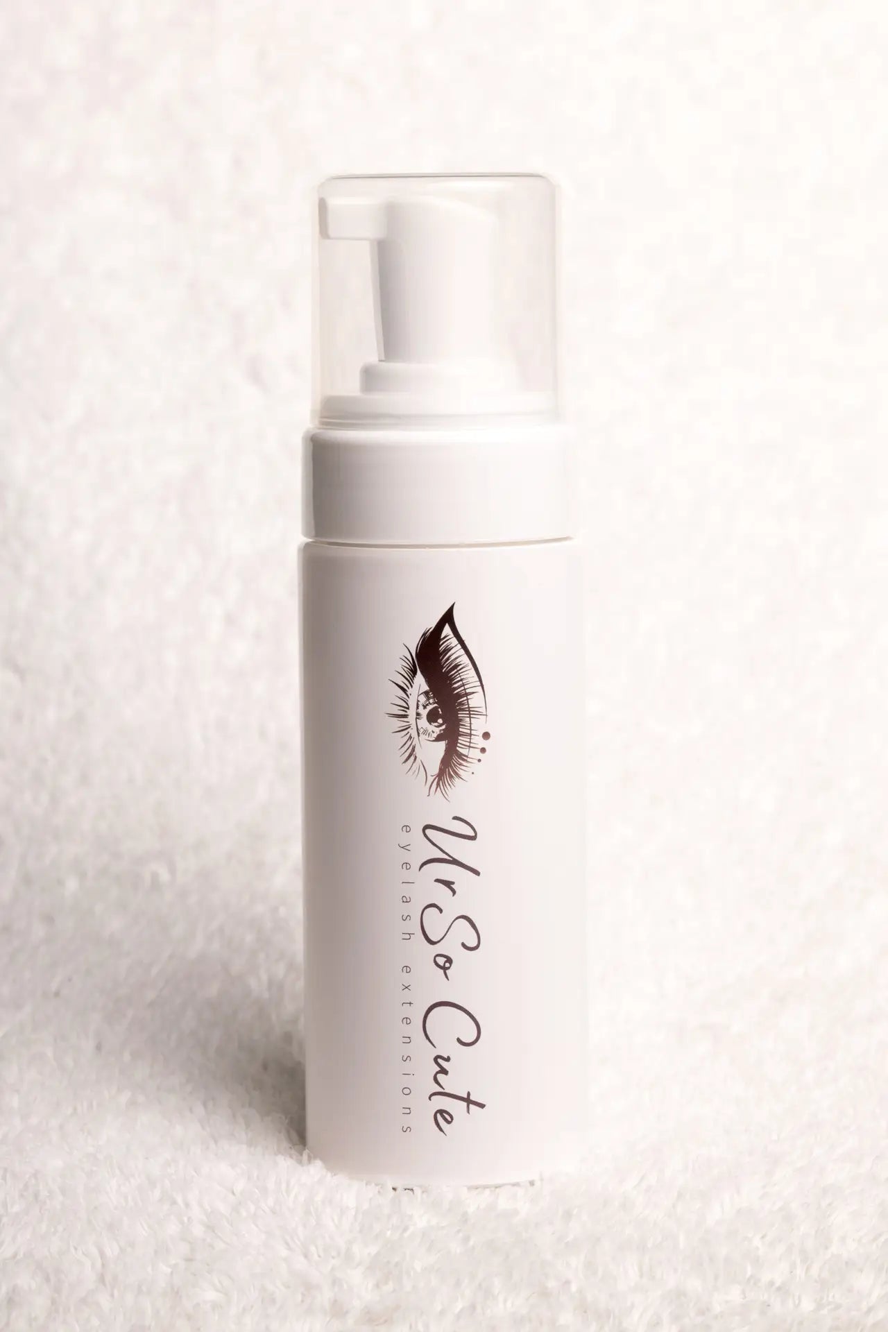 White cylindrical lash foam shampoo bottle with clear pump and black eyelash illustration foaming cleanser lash