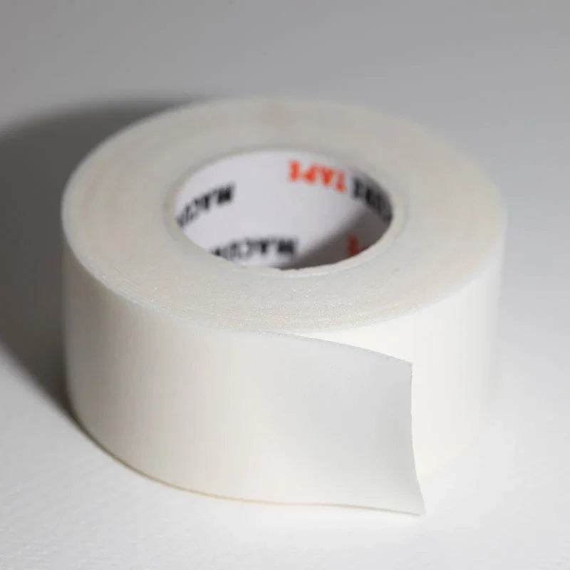 A roll of white microporous foam tape with a partially peeled strip featuring the 3m brand logo on the inner core