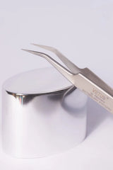 Silver Vetus precision tweezers with curved pointed tips and sleek metallic finish ideal for hypoallergenic adhesive glue use