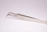 Silver stainless steel tweezers with curved pointed tips and engraved markings ideal for hypoallergenic adhesive glue use