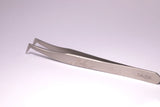 Silver precision tweezers with angled tips and engraved markings ideal for minimizing allergic reactions in lash techs malta