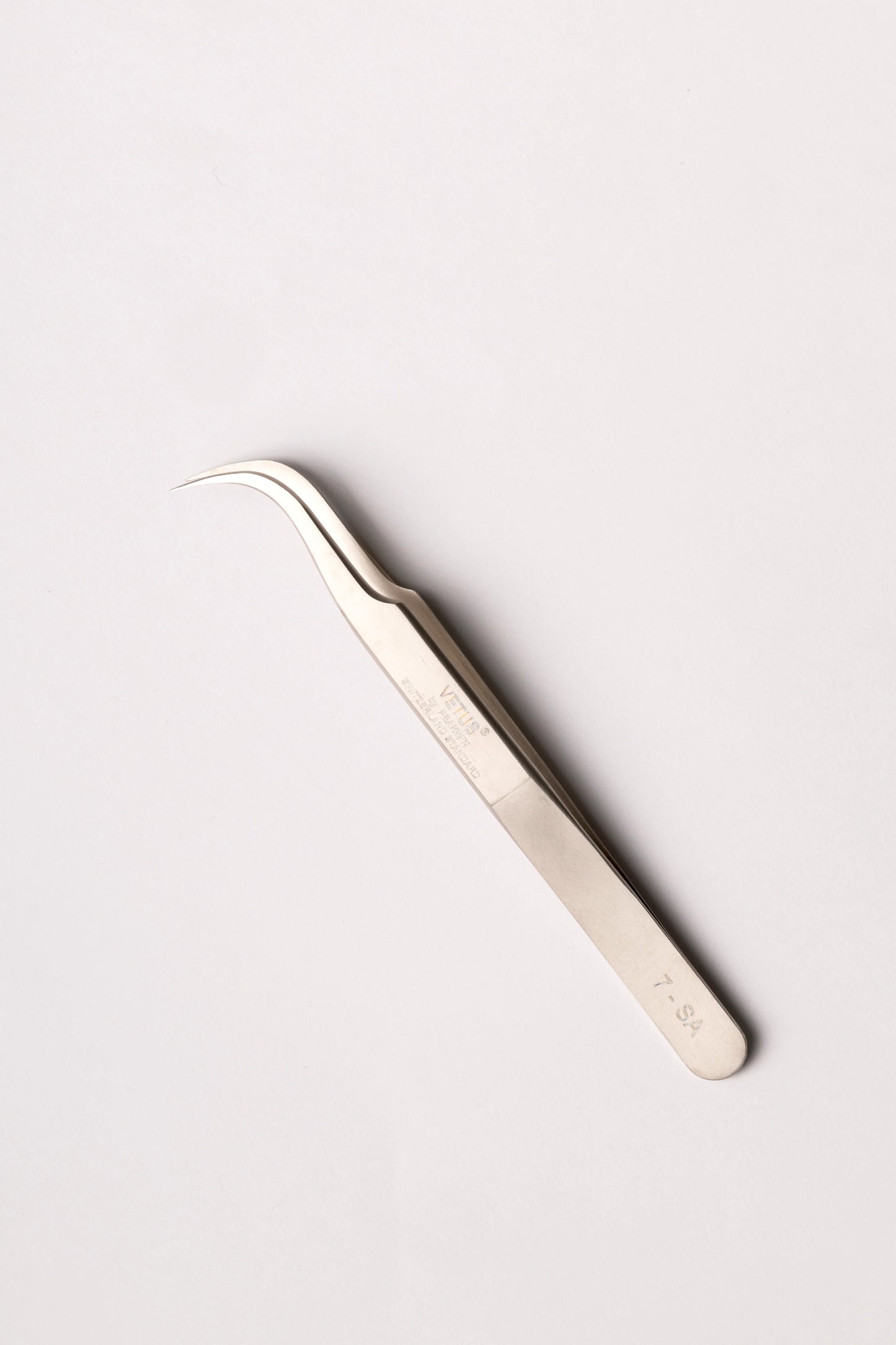 Silver precision tweezers with curved fine tips and sleek metallic finish as a solution for lash techs in malta
