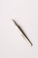 Silver precision tweezers with curved fine tips and sleek metallic finish as a solution for lash techs in malta