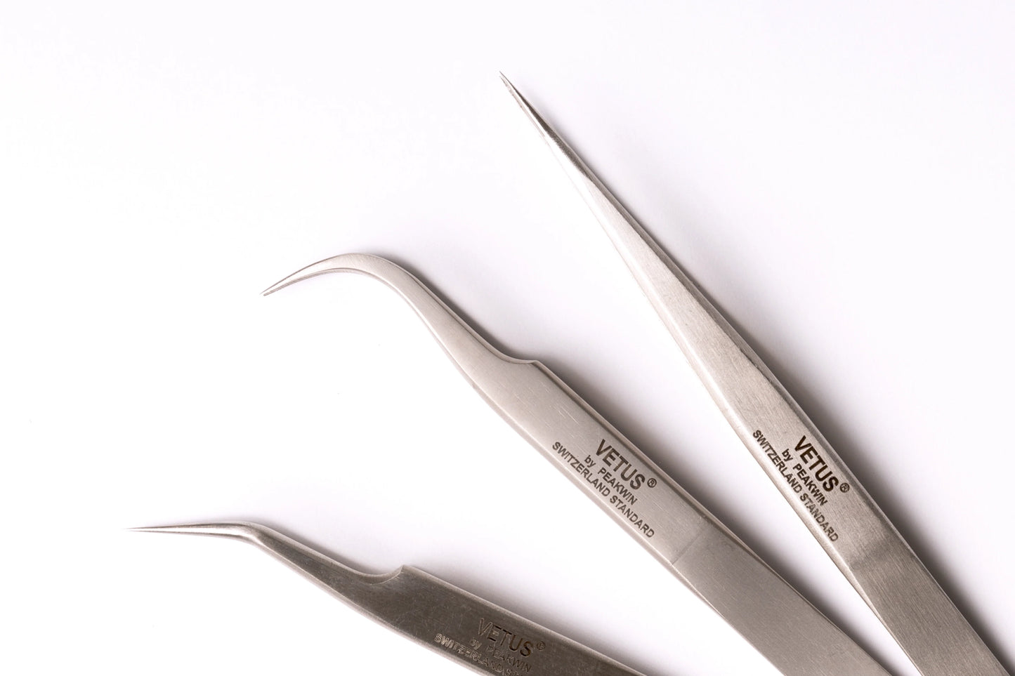 Set of three silver-toned vetus precision tweezers with curved and straight tips hypoallergenic adhesive glue solution for lash techs in malta